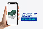 Hand probiert Augmented Reality bei Sessel.